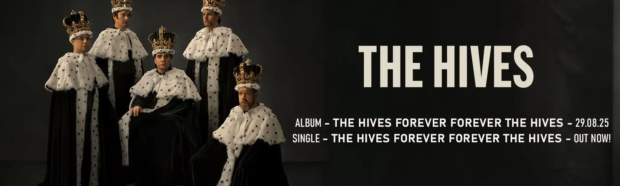 Five men dressed in black robes with white and black spotted fur collars and golden crowns.